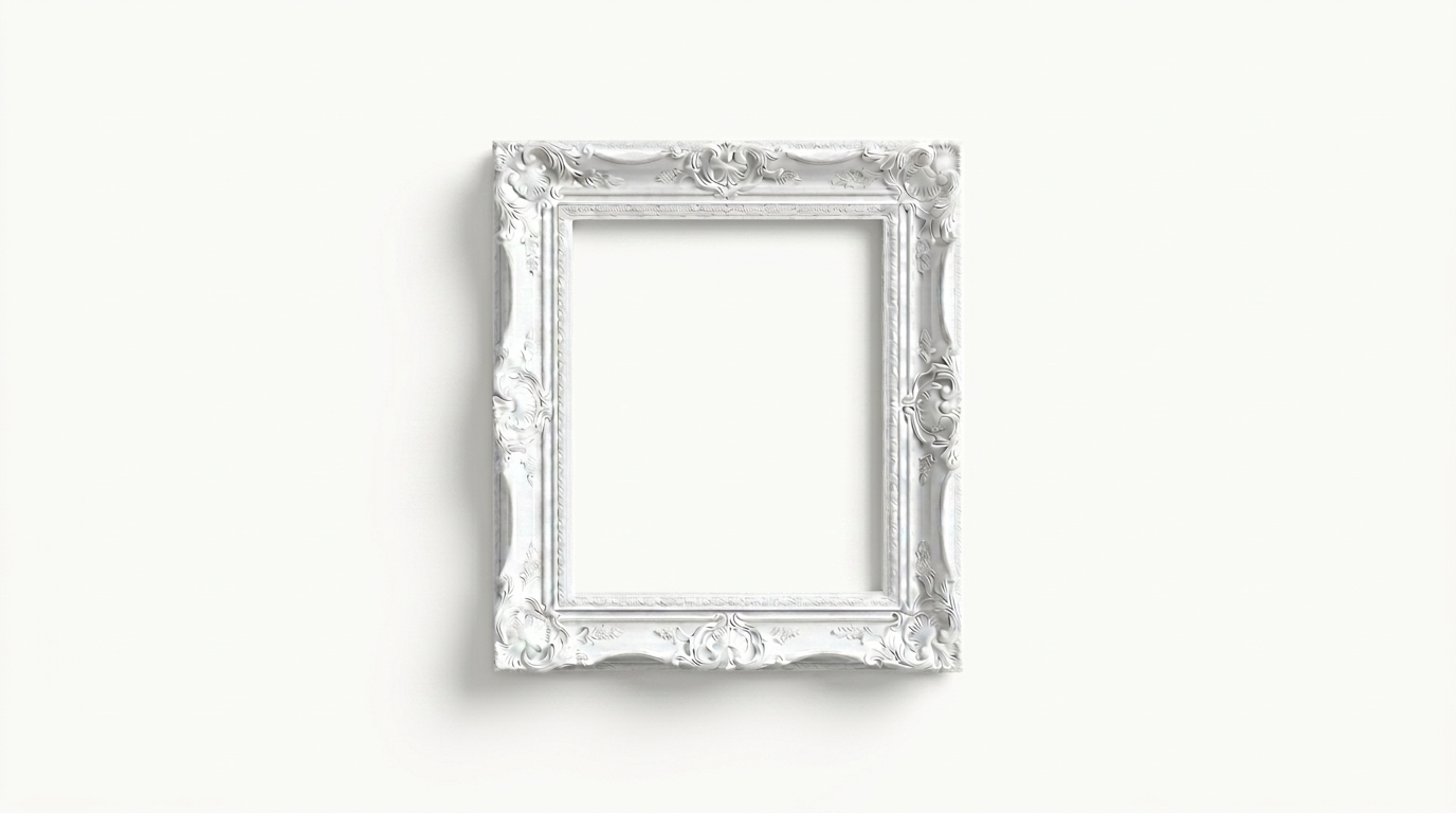 An ornate white picture frame displayed on a light gallery wall